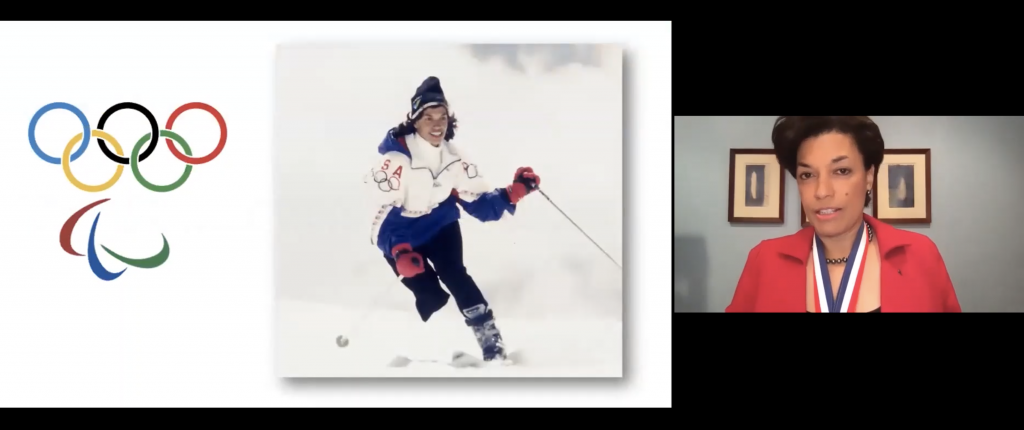 Bonnie St. John appears to the right of a slide with the Olympic and Paralympic logos, as well as a photo of her skiing for the U.S.